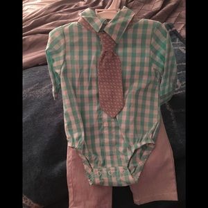 Collared shirt with tie and pants.